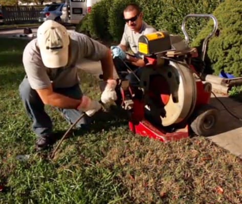 Mark and Brandon cleaning a main drain line.