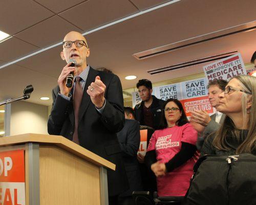 Thresholds' COO Mark Furlong speaks to the crowd at a Medicare/Medicaid rally in Chicago.