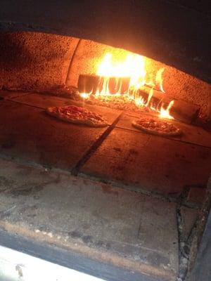 Pizzas cook in under 2 minutes in our all wood fired Italian brick oven.