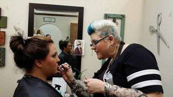 Stylist Melissa doing makeup on a client