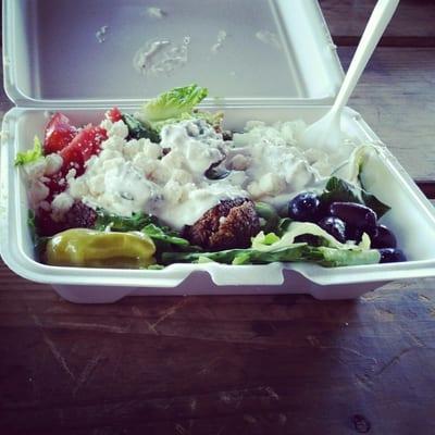 Greek salad with falafel and tzatziki sauce as dressing.