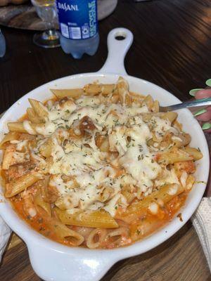 Penne a la Vodka with Chicken, bottle of water and a cold beer