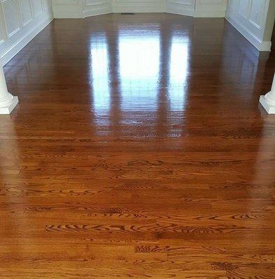 Hardwood floor revitalization  -  professional hardwood floor cleaning and application of multiple coats of a finish to make it shine