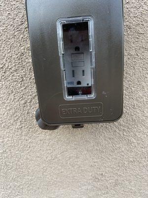 Outside Weather proof GFCI receptacle with weather cover.