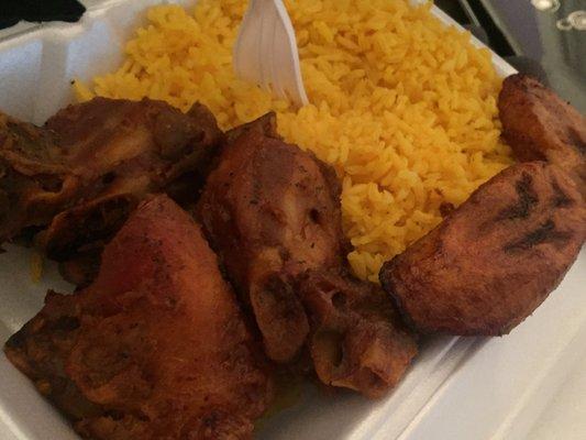 Oven baked chicken over yellow rice with maduros