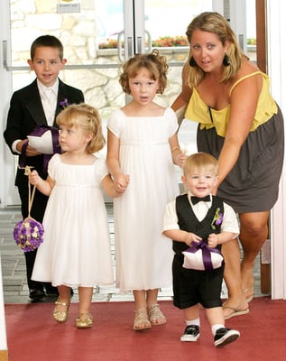 Renee getting the adorable flower girls and ring bearers down the aisle.