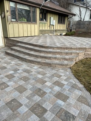 Backyard landscape renovation includes new paver patio. In Denver CO