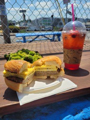 Sausage sandwich and infused redbull with pomegranate.