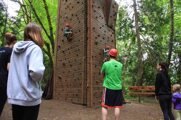 Campers climb the tower.