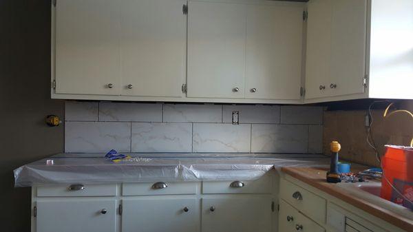 New tile backsplash being installed will upgrade any kitchen.