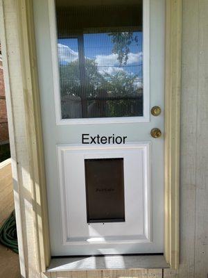 The exterior door is framed, insulated, caulked, and trimmed.