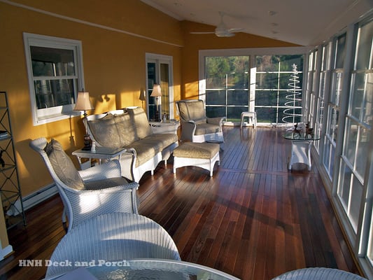 Screen porch with hardwood flooring and Ezebreeze sliding panels.