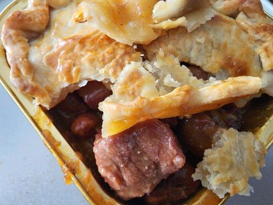 Smoked brisket pot pie in a beefy BBQ gravy with a flaky crust.