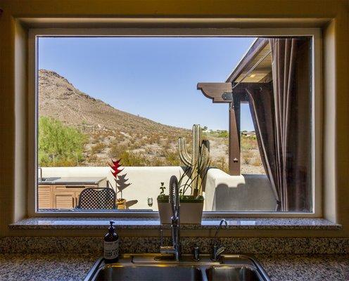 The view from the kitchen window over their new outdoor living area and kitchen.  Lookout Mountain, Phoenix, AZ