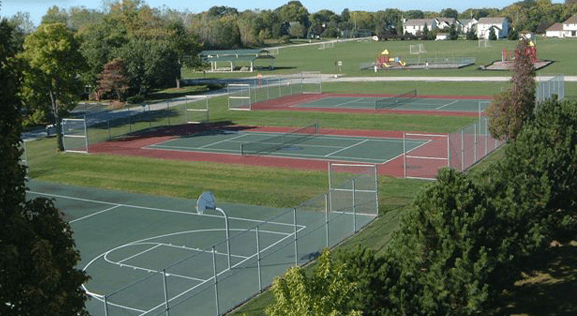 Heigel Sports Park next to Sunnyside Tower with two tennis courts, basketball court, soccer fields, two playgrounds.