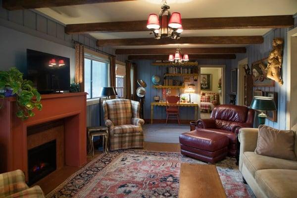 Living room with flat screen TV, wireless, a work desk and plenty of naturalist books