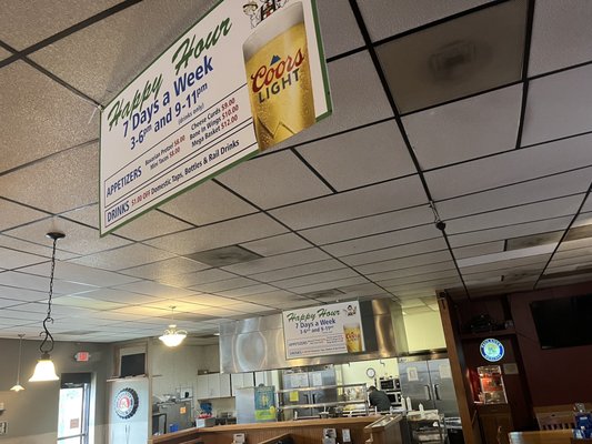 Happy Hour Specials and a view of the kitchen.