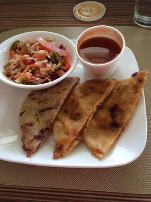 Bean & pork pupusas taken to go and halved at home, with sides of salsa and pickled veggies.