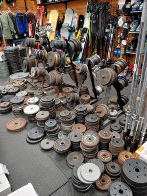 Used weights and snowboard behind