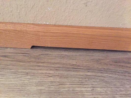 They just stapled old baseboard on without fixing the gap