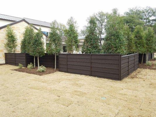 4' tall cedar horizontal fence with top cap designed and built by Green and Son. Dallas, Texas.