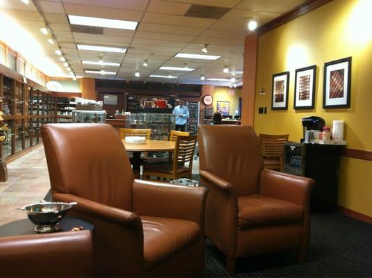 Nice circle of leather chairs infront of a flat screen tv