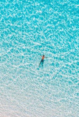 Man floating in blue water