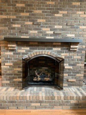 Mantel, doors, and new gas logs update this homes living room.