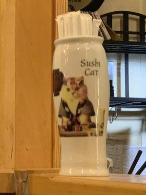 Straw container that says "Sushi Cat" with a cat in a traditional robe on it.