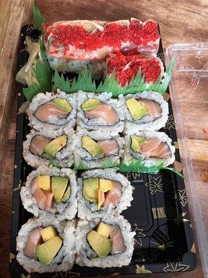 Partly eaten meal, it was so good I couldn't wait - Salmon mango avocado roll, salmon avocado, Christmas roll .