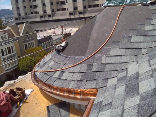 Composition shingle roof with custom copper gutter.