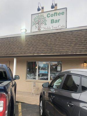 Storefront, between Slice of Heaven Pizza & Ulbrich's Hometown Bakery. Across street from Speedway Cafe Gas Station.