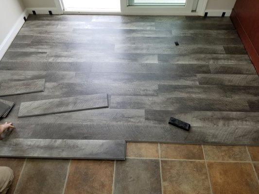 Luxury vinyl flooring covering old outdated tile floor