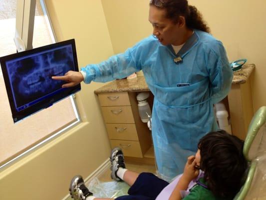 Each room has a TV. You can watch your favorite show or look at your x-rays:) The assistant showing Noah his incoming teeth:)