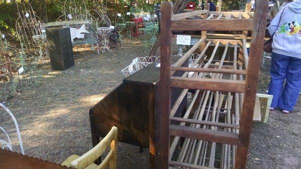 Garden structures in the distance.  This wooden piece appears to be a very old bookcase.