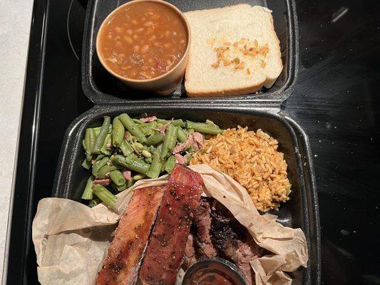 2 meat with 2 sides on a kids plate. The dirty rice was more of a Spanish rice with 2 baby ribs and Cajun green beans with baked beans.