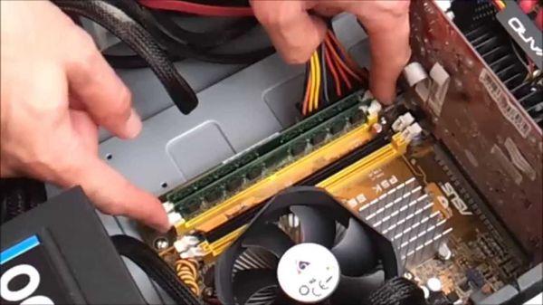 Photo of one of our technicians upgrading the memory in a client desktop.