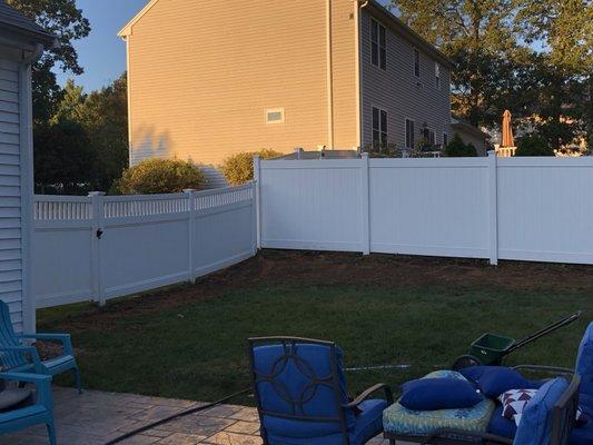 Fence installation and lawn repair along property line.