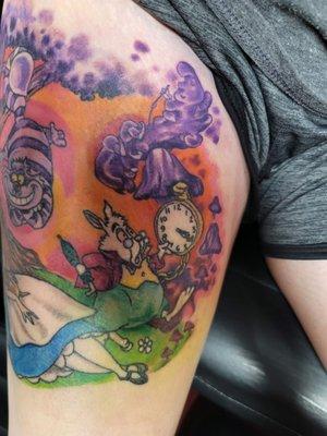 Alice in wonderland on the thigh