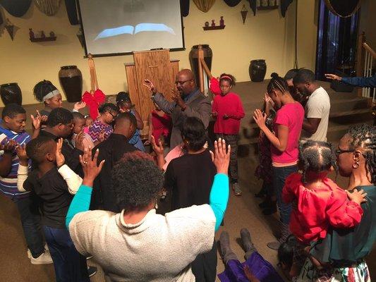 Pastor Melvin praying for the youth