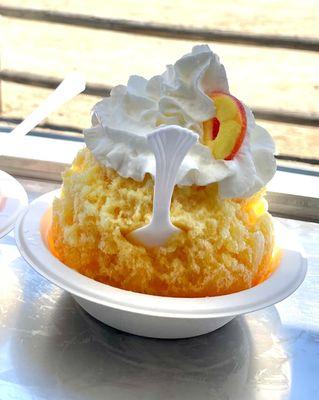 Peaches and Cream Shave Ice ( peach and vanilla syrups, vanilla ice cream, peach snow cap, whipped cream and a peach ring)