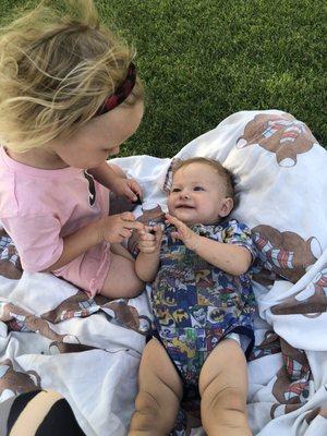 This is us playing in the grass outside the learning Center afterwards. Ariel likes to wind down as a family after preschool.