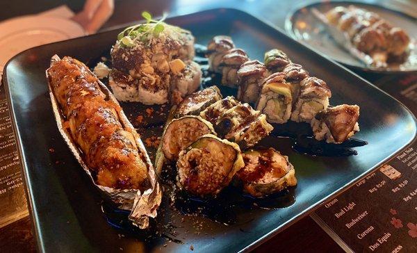 Left: Hawaiian BBQ Salmon Roll, top Dynamite Roll, beneath Las Vegas roll and right Dragon Roll