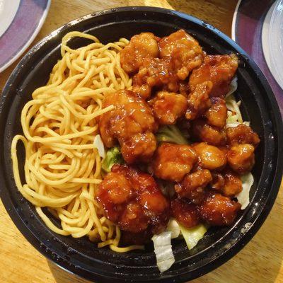 The fantastic orange chicken with veggies and noodles.