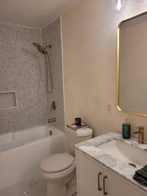 This was a bathroom upgrade including new marble flooring, double sink vanity, soaking tub, and custom shower surround with built in niche,