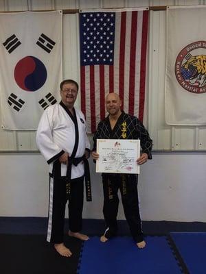 Master Instructor Popham receiving is 4th Dan Black Belt!  Way to go Mr. Popham, we are so proud of you!