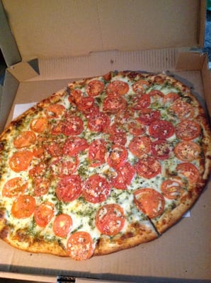 Pesto: fresh pesto sauce topped with mozzarella cheese, fresh plum tomatoes, fresh garlic and spices