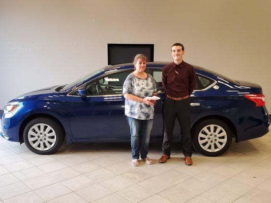 Kaleb Kincaid giving the keys of our new Sentra S to Crystal