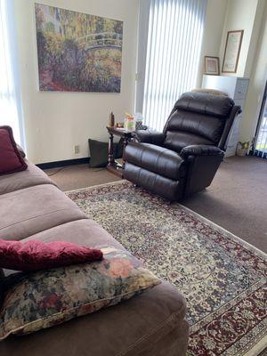 Bright, well-lit corner office. People typically describe it as "warm," "comfortable," and "feels like home."