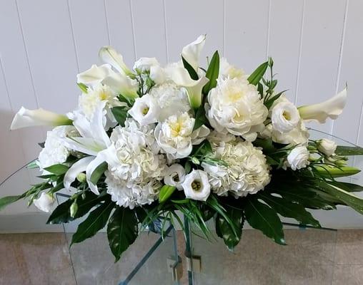 Casket Spray .  white hydrangea, lilies, peonies, lisianthus and mini calla lilies.